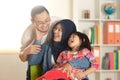 Muslim parents and little babgy girl, father and mother with their daughter, happy smiling plays together