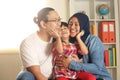 Muslim parents and little babgy girl, father and mother with their daughter, happy smiling plays together