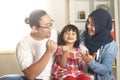 Muslim parents and little babgy girl, father and mother with their daughter, happy smiling plays together