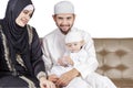 Muslim parents and their son sitting on sofa Royalty Free Stock Photo