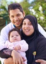 Muslim, park and portrait of parents with child for bonding, ramadan and outdoors together. Islam, happy family and Royalty Free Stock Photo