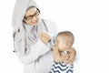 Muslim pediatrician checking her patient