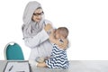 Muslim pediatrician examining her patient on studio Royalty Free Stock Photo