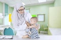 Muslim pediatrician examining little baby