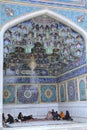 Muslim pilgrims group rests in outer niche of mosque, Iran.