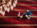 Muslim prayer father and son in mosque praying and reading holly book Quran together islamic education concept Royalty Free Stock Photo