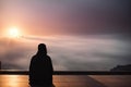 Muslim praying in a mystical environment, silhouette, no face visible, generative ai, color grading Royalty Free Stock Photo