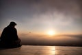 Muslim praying in a mystical environment, silhouette, no face visible, generative ai, color grading Royalty Free Stock Photo