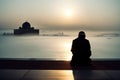 Muslim praying in a mystical environment, silhouette, no face visible, generative ai, color grading Royalty Free Stock Photo