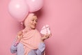 Muslim pretty woman in pink hijab, getting happy present for International Women& x27;s or Mother& x27;s Day, expressing