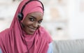 Muslim Remote Jobs. Closeup Of Black Islamic Lady In Hijab And Headset Royalty Free Stock Photo