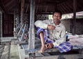 Muslim rural asian man sitting in the courtyard of his house