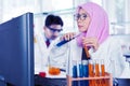 Muslim scientist working with chemical tube