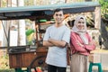 muslim small business entrepreneur with their food cart at the background