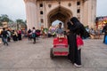 A muslim street vendor selling ice cream to women sightseeing at the famous Charminar monument