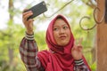 Muslim student lifestyle - young beautiful happy and cheerful Asian Indonesia student girl wearing Islam traditional hijab head Royalty Free Stock Photo