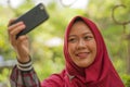 Muslim student lifestyle - young beautiful happy and cheerful Asian Indonesia student girl wearing Islam traditional hijab head Royalty Free Stock Photo