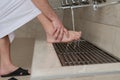 A Muslim takes ablution for prayer. Islamic religious rite