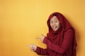 Muslim Teenage Girl Smiling and  Pointing to The Side With Copy Space Royalty Free Stock Photo