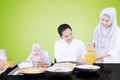 Muslim wife pouring orange juice Royalty Free Stock Photo