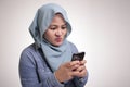 Muslim Woman Angry While Reading Text Message on Smart Phone Royalty Free Stock Photo