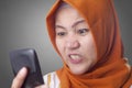 Muslim Woman Angry While Reading Text Message on Smart Phone Royalty Free Stock Photo