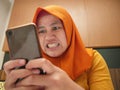 Muslim Woman Angry While Reading Text Message on Smart Phone Royalty Free Stock Photo