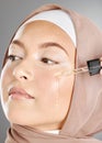 Muslim woman beauty, facial serum or essential oil, aesthetic makeup or glowing skincare on studio background. Islamic