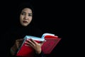 Muslim woman in black Muslim veil hijab reading the Qur& x27;an