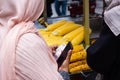 Muslim woman buying corn on street stall