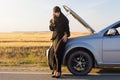 Muslim woman calling help phone near open hood of car Royalty Free Stock Photo