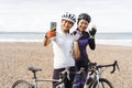 muslim woman cyclist taking selfie photo together at the beach Royalty Free Stock Photo