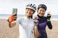 muslim woman cyclist taking selfie photo together at the beach Royalty Free Stock Photo