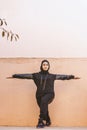 Muslim woman does physical exercises. Middle-eastern woman in hijab training outdoors. Doing physical exercises on fresh air.