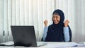 Muslim woman is doing a happy expression in completing her goals