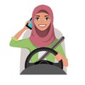 Muslim woman driving a car talking on the phone. Muslim woman wearing hijab