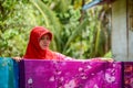 Muslim woman drying Batik fabric Royalty Free Stock Photo