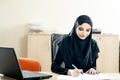 Muslim woman fills the documents