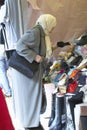 Muslim Woman at flea market shopping for shoes, Paris, France