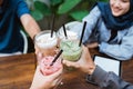 Muslim woman with friend toast her drink Royalty Free Stock Photo