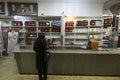 Muslim woman in front of cash counter at a store cashier staff behind the glass