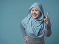 Muslim Woman Having Bright Idea, Looking at Camera Smiling and Pointing Up Royalty Free Stock Photo