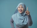 Muslim Woman Having Bright Idea, Looking at Camera Smiling and Pointing Up Royalty Free Stock Photo