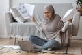 Muslim Woman Having Problems While Working On Laptop At Home Royalty Free Stock Photo