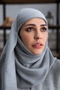 Upset muslim woman in hijab looking