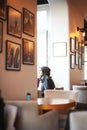 Muslim woman looks out the window in a cafe