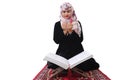 Muslim woman in hijab and traditional clothes praying for Allah against white background, quaran holy book religion concept, copy Royalty Free Stock Photo