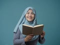 Muslim Woman Holding Book, Thinking and Smiling Royalty Free Stock Photo