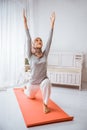 muslim woman instructor wearing hijab tutoring anjaneyasana yoga pose pilates on mattress