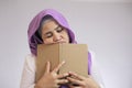 Muslim Woman Looks Tired and Sleepy when Learning or Reading Book